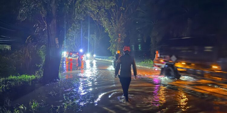 Personel Batalyon D Pelopor Sigap Atur Lalu Lintas di Tengah Banjir Poros Palopo–Masamba